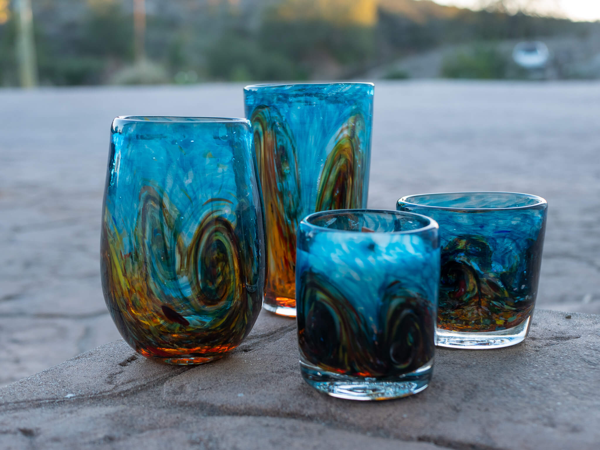 stemless wine glass, tumbler, rocks glass and candle in turquoise gold with accents in yellow and orange